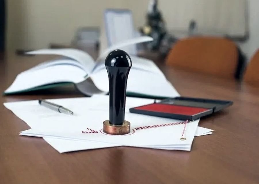Notary stamp and ink pad on a desk